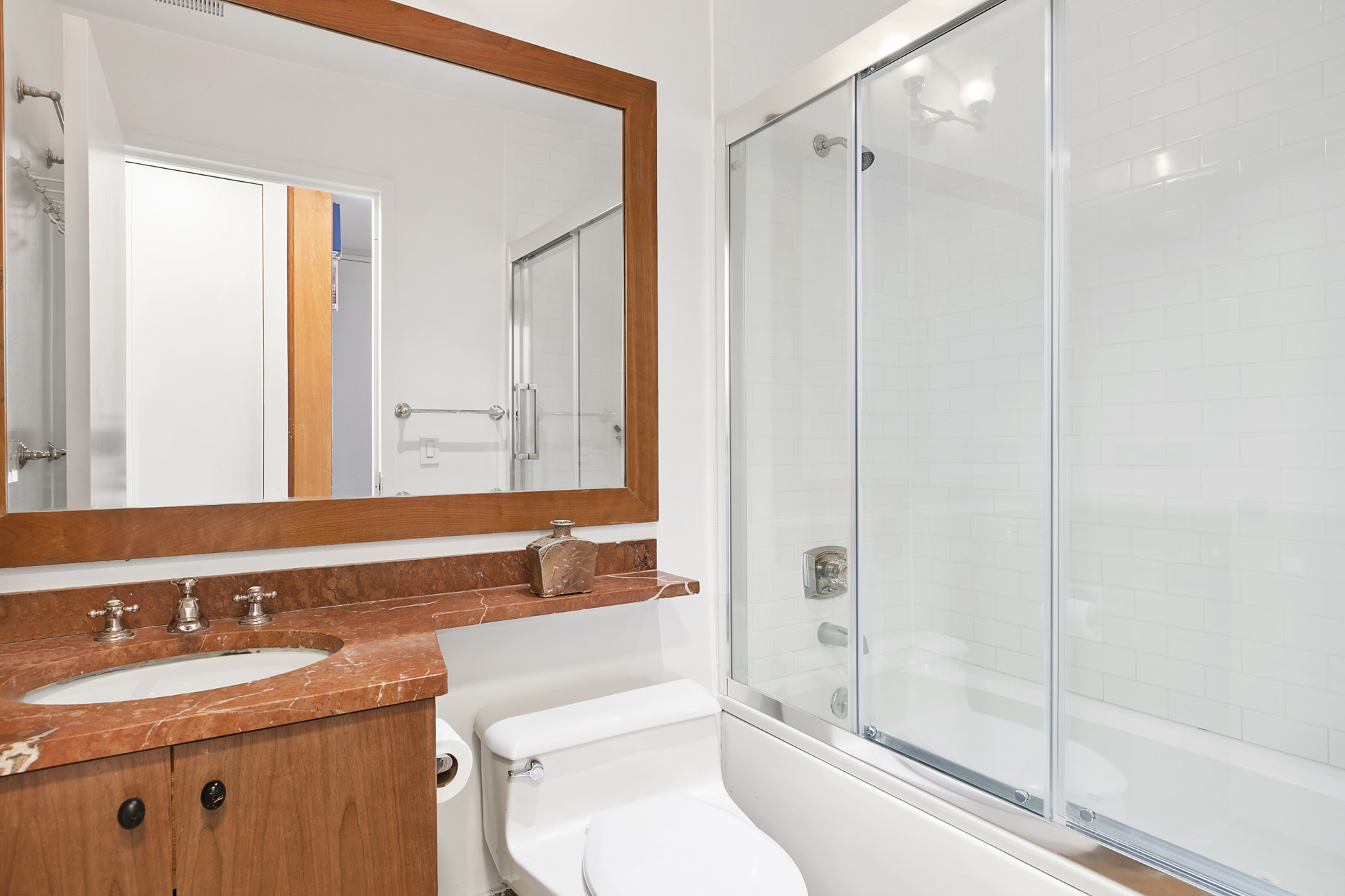130 West 79th Street, Unit 17A Manhattan, NY 10024 - Photo 10 of 15 a bathroom with a granite countertop sink toilet and shower