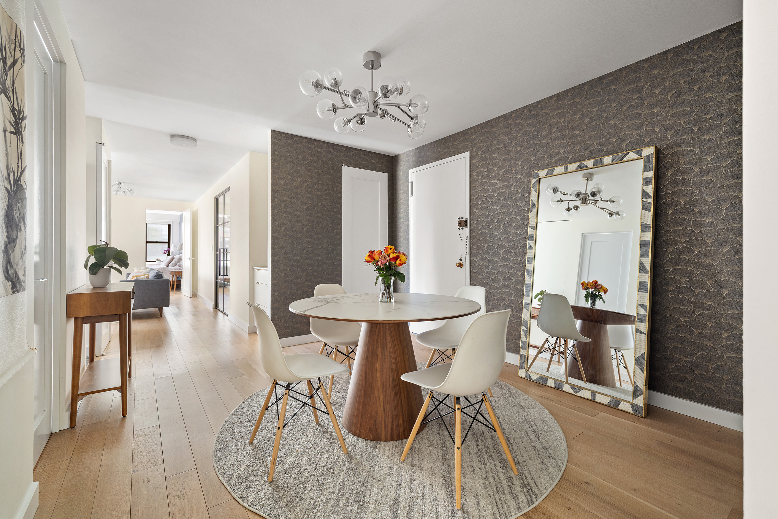 1065 Park Avenue, Unit 10CD Manhattan, NY 10128 - Photo 2 of 10 a living room with furniture a dining table and wooden floor