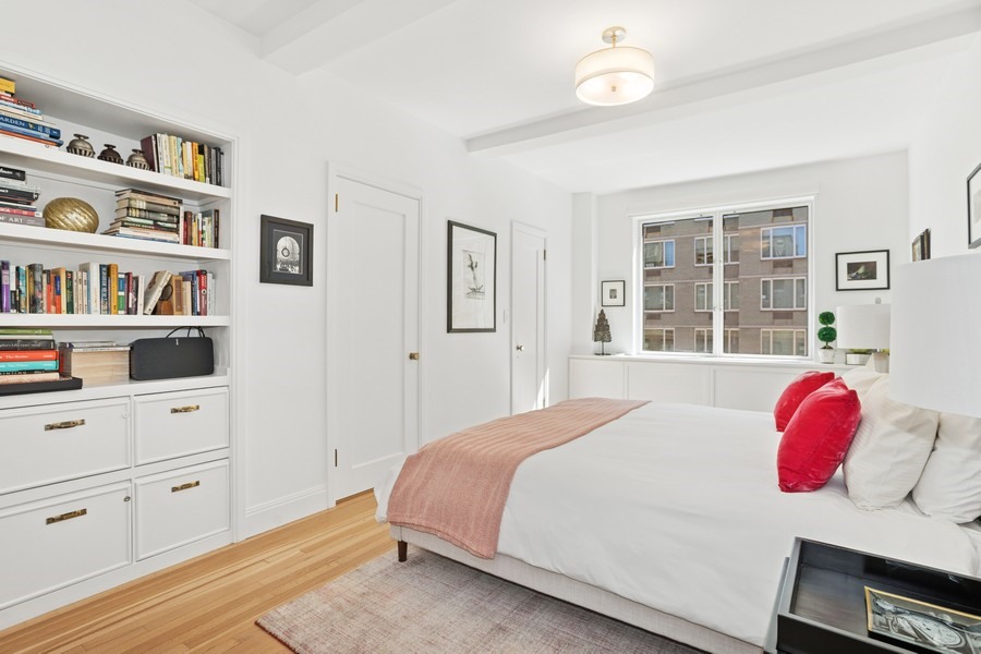 350 East 57th Street, Unit 14B Manhattan, NY 10022 - Photo 11 of 14 a bedroom with a bed and a book shelf
