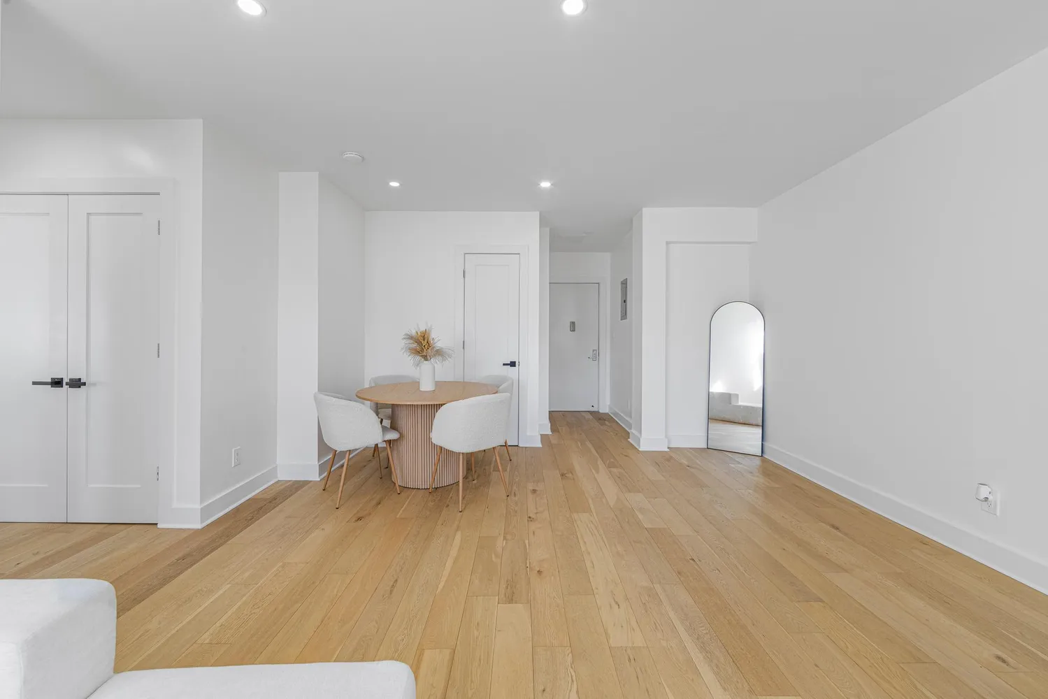 a view of a room with wooden floor and furniture