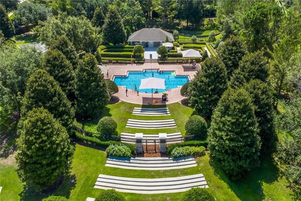 352 Giovani Boulevard Clermont, FL 34715 - Photo 4 of 46 a front view of a house with a yard potted plants and large trees