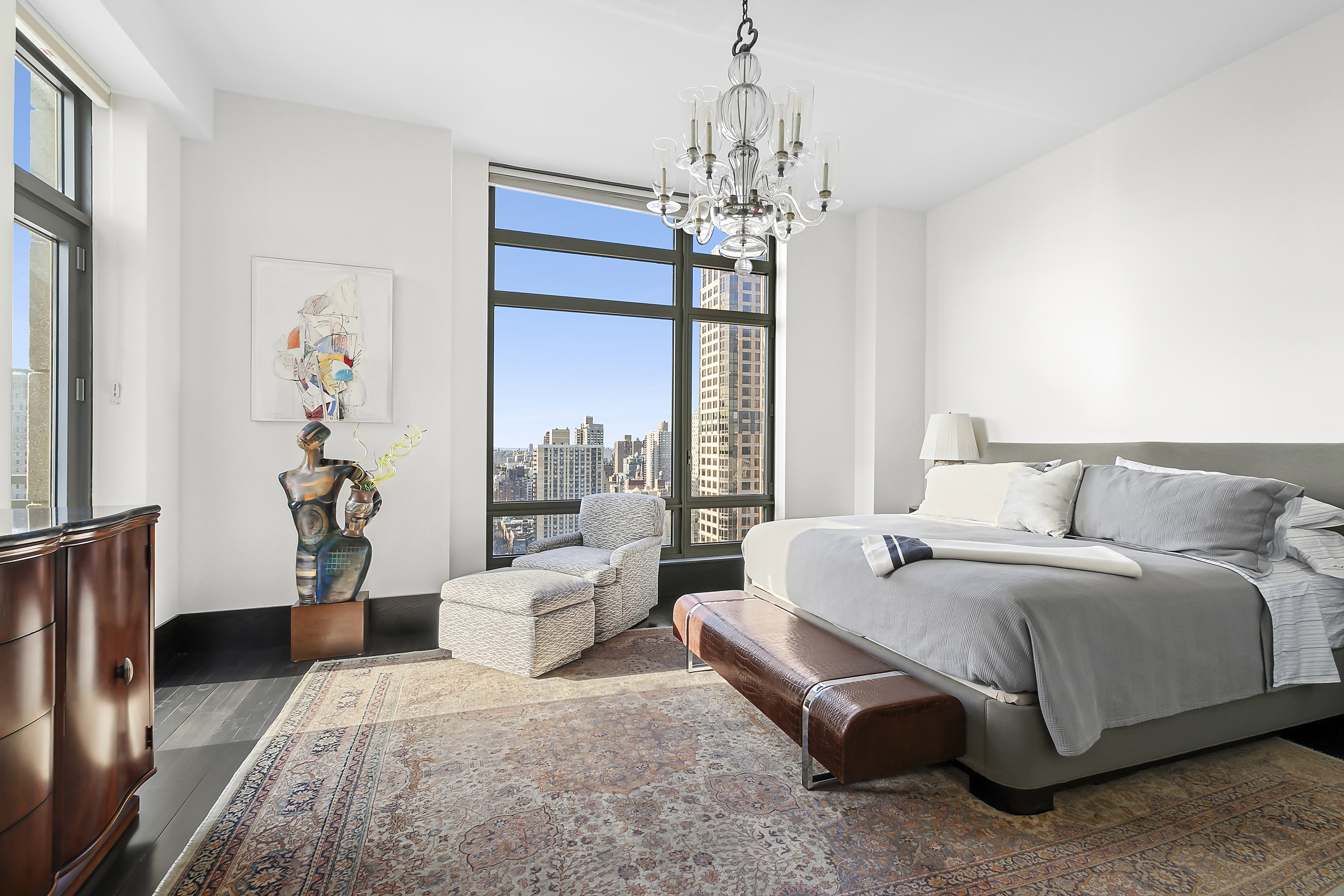 450 East 83rd Street, Unit PH1B Manhattan, NY 10028 - Photo 7 of 15 a spacious bedroom with a bed and a chandelier