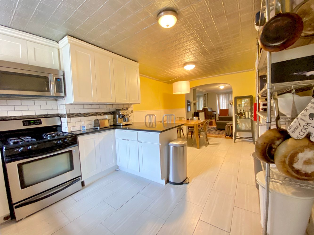 390 5th Street, Unit 1 Brooklyn, NY 11215 - Photo 11 of 15 a kitchen with stainless steel appliances granite countertop a stove a sink and a microwave