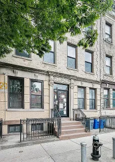 a front view of a building with glass windows and door