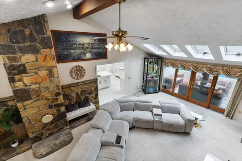 a living room with furniture and a chandelier