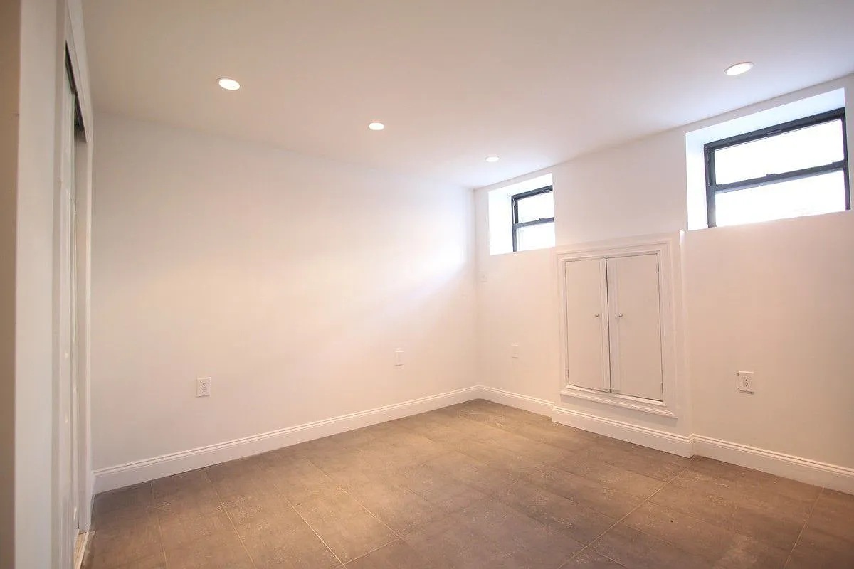 186 Howard Avenue Brooklyn, NY 11233 - Photo 11 of 14 an empty room with windows and closet