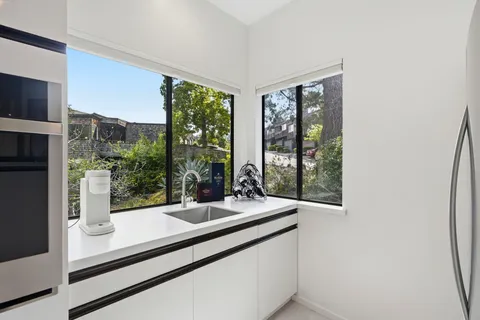 a view of a counter top window and an entryway