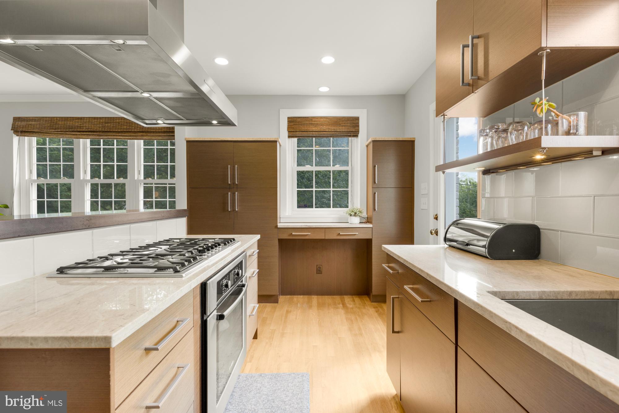 2611 Ross Road Chevy Chase, MD 20815 - Photo 16 of 37 a kitchen that has a sink a stove and a wooden cabinets