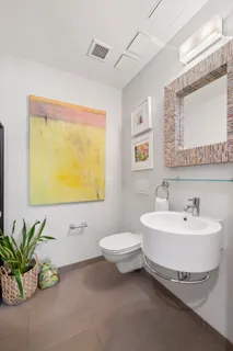 a bathroom with a sink a mirror and a toilet