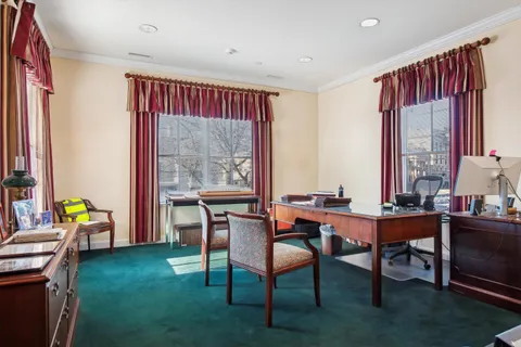 a dining room with furniture window and wooden floor