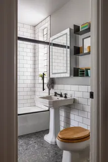a bathroom with a sink a toilet and shower