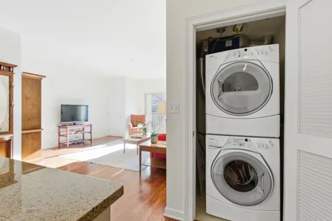 a living room with furniture and a washer dryer