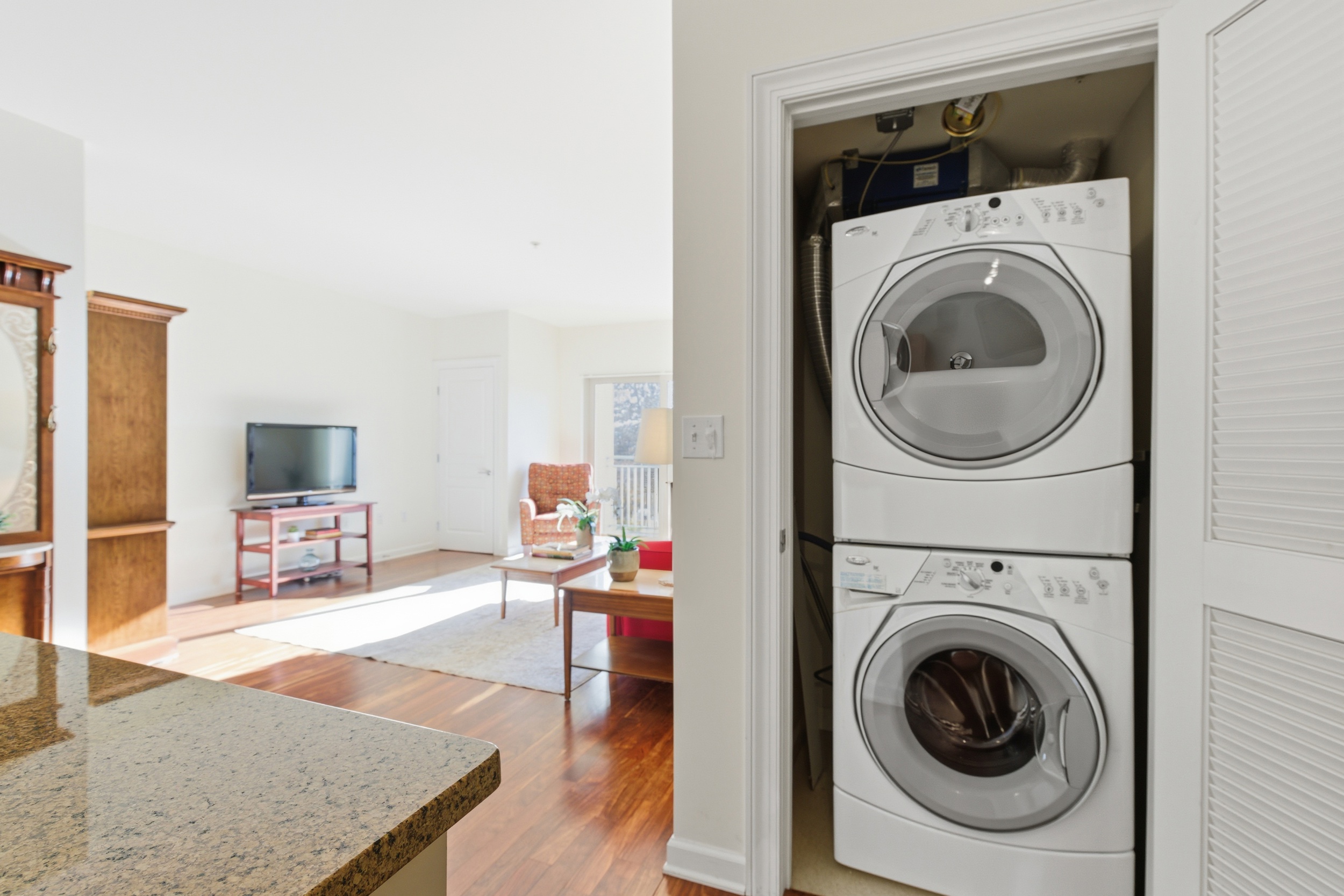 Repton Circle, Unit 3204 Watertown, MA 02472 - Photo 14 of 18 a living room with furniture and a washer dryer