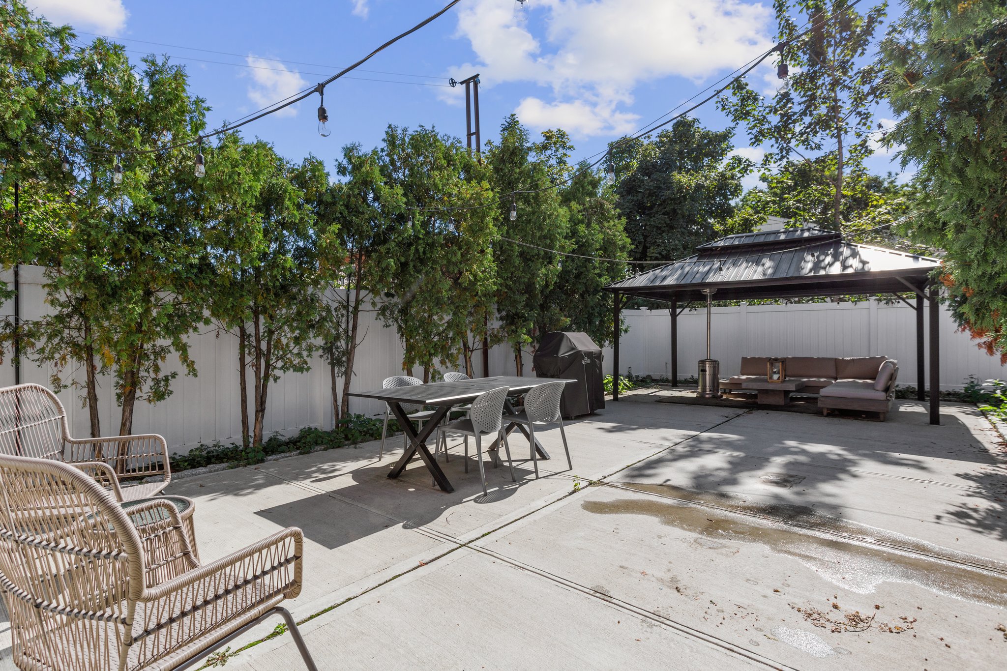 22-45 47th Street, Unit 3 Queens, NY 11105 - Photo 12 of 14 a view of a patio with a table and chairs under an umbrella
