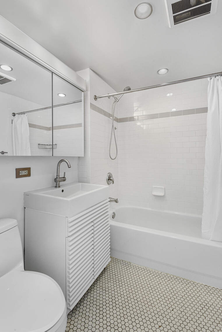 520 West 23rd Street, Unit PH16F Manhattan, NY 10011 - Photo 7 of 17 a white bath tub sitting next to a white sink