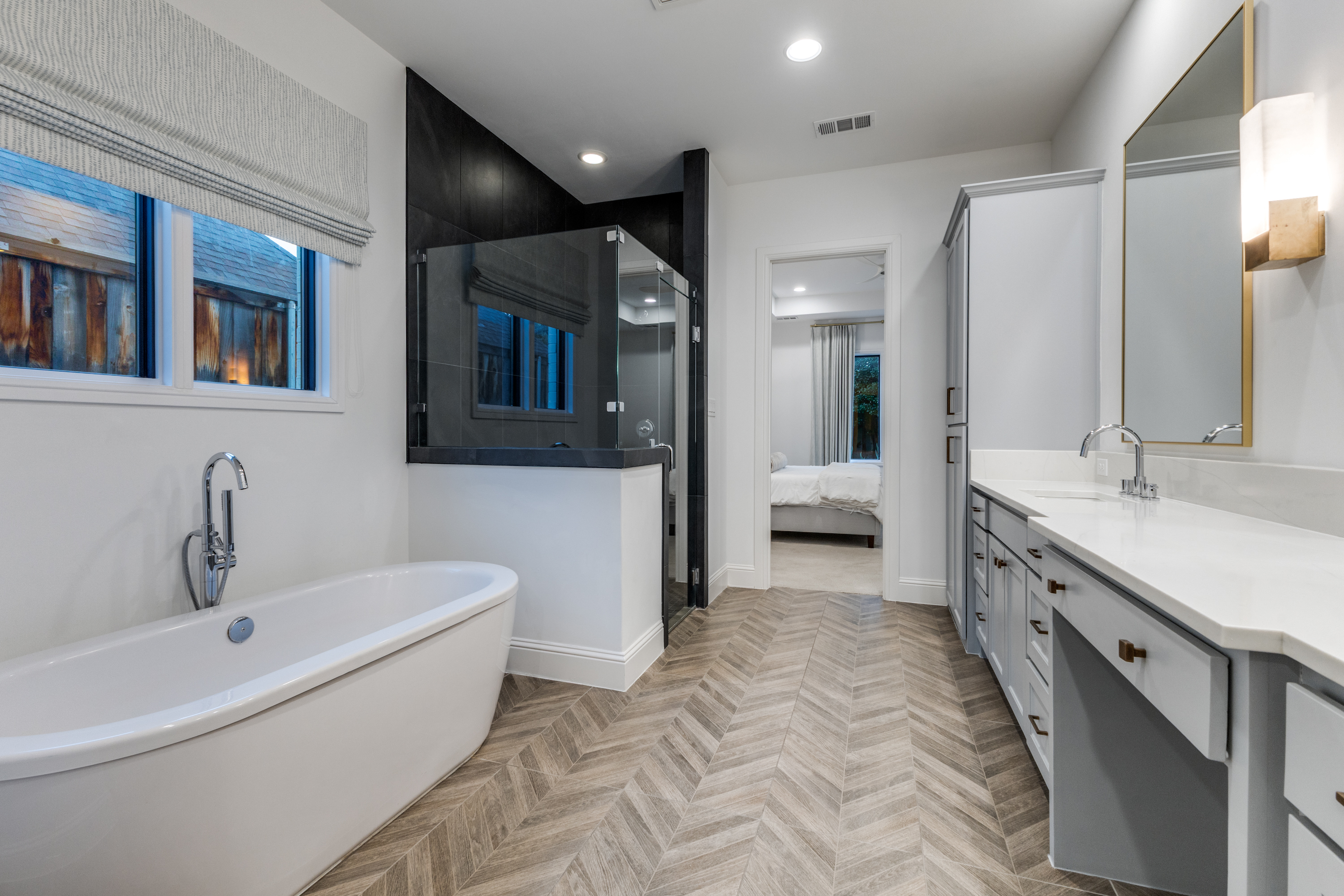 4042 Dunhaven Road Dallas, TX 75220 - Photo 21 of 34 a spacious bathroom with a double vanity sink a mirror and a bathtub
