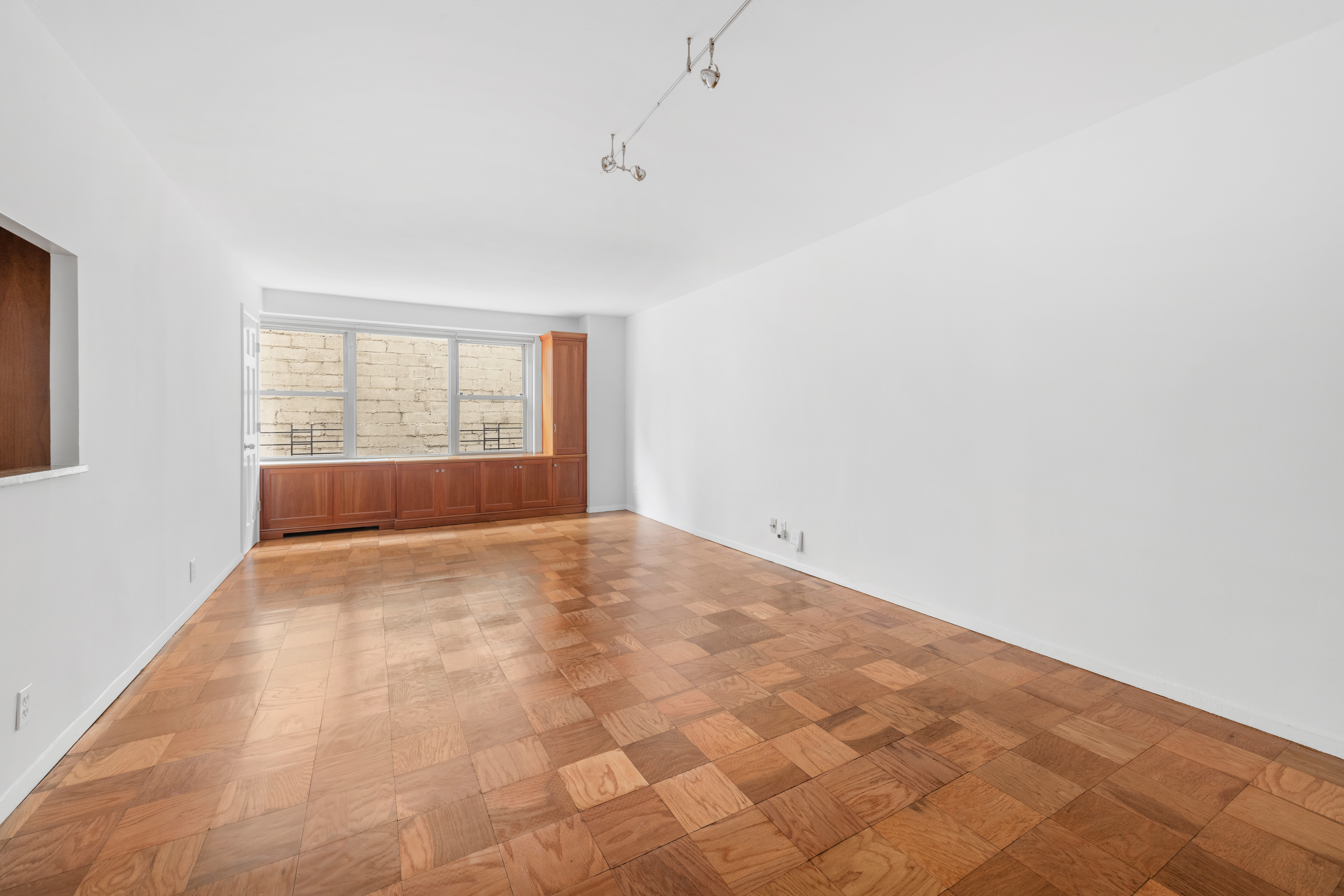 370 East 76th Street, Unit C607 Manhattan, NY 10021 - Photo 2 of 12 an empty room with a empty space and windows