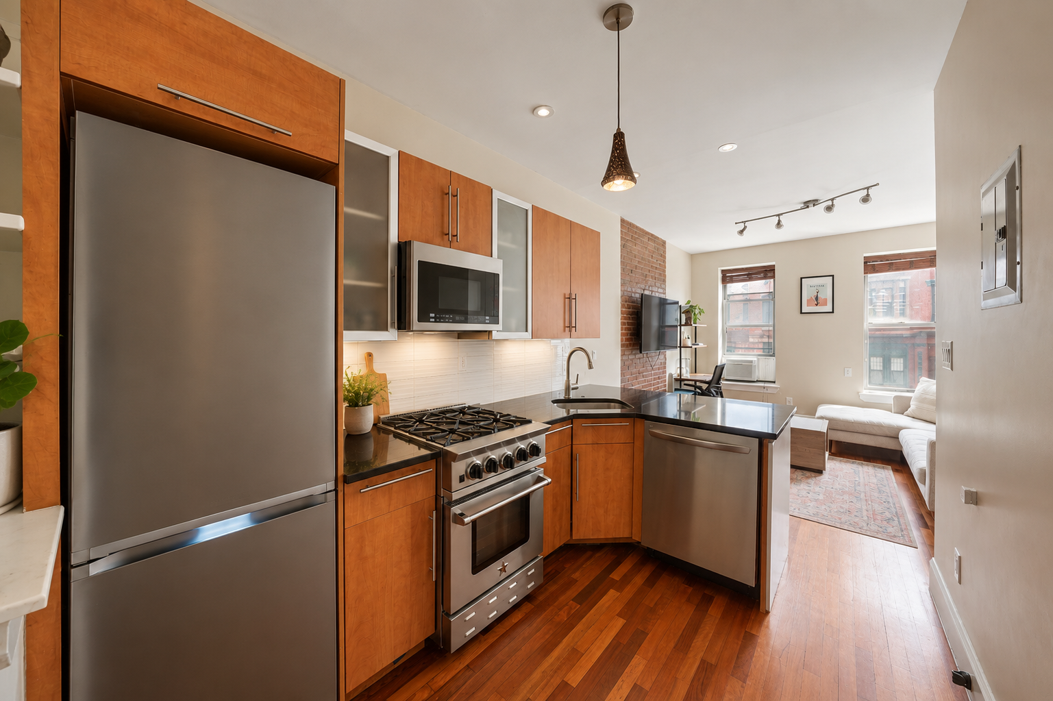 161 West 133rd Street, Unit 2B Manhattan, NY 10030 - Photo 11 of 15 a kitchen with stainless steel appliances granite countertop a refrigerator a sink dishwasher a stove and white countertops with wooden floor