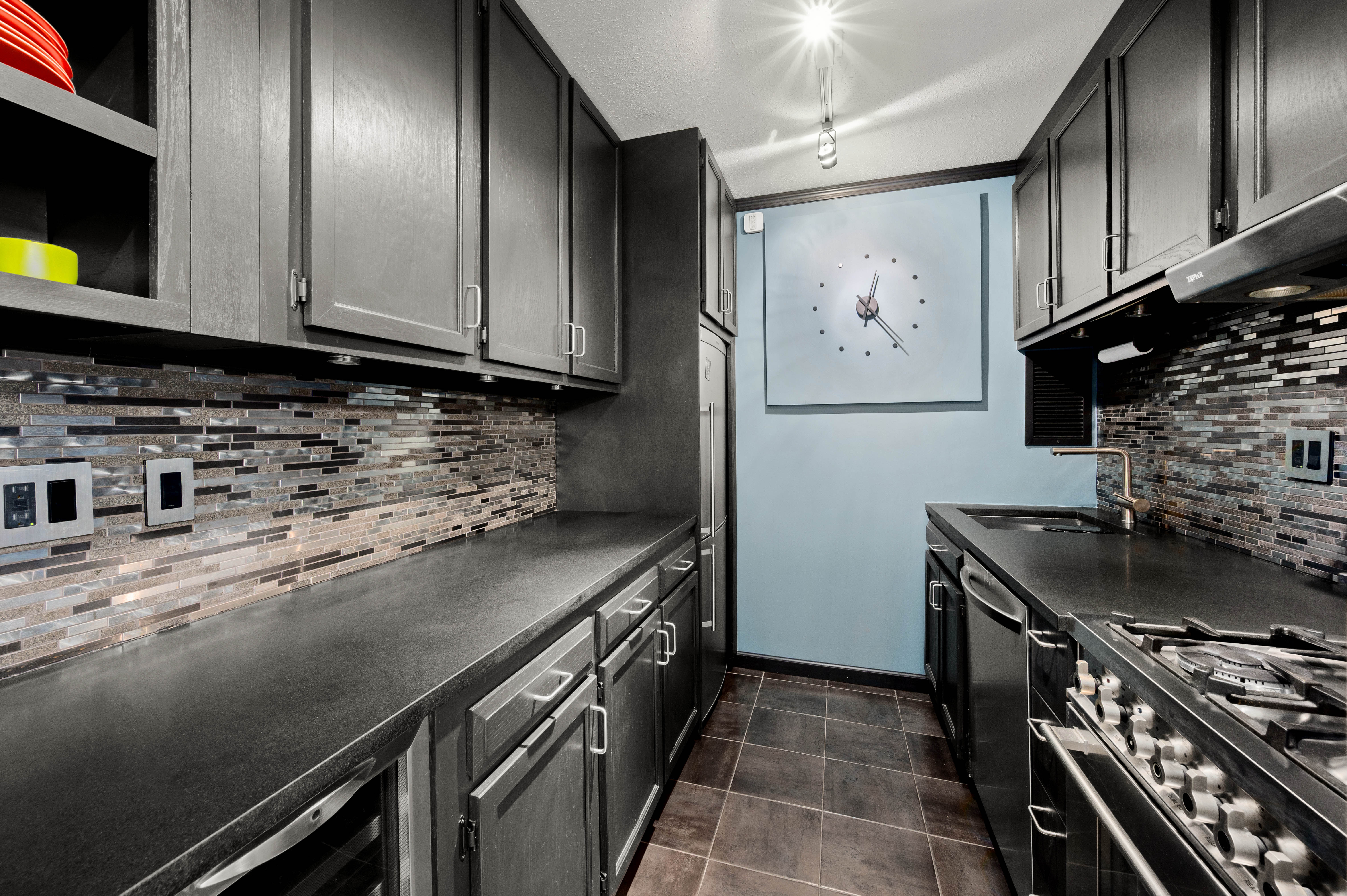 2025 Broadway, Unit 3A Manhattan, NY 10023 - Photo 2 of 8 a kitchen with stainless steel appliances granite countertop a stove a sink and a microwave