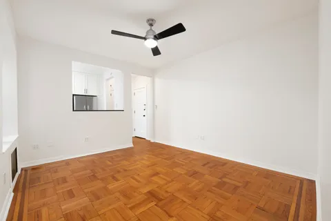 a view of empty room with wooden floor