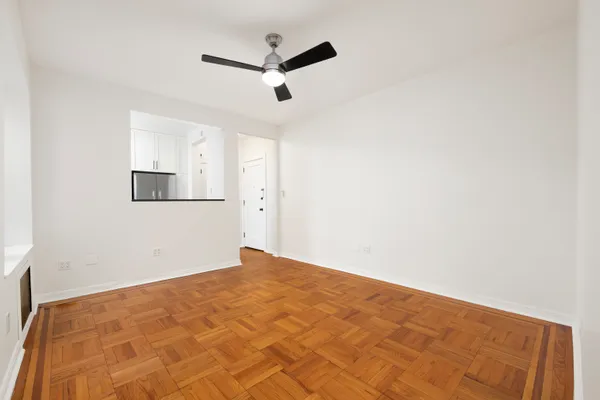 a view of empty room with wooden floor