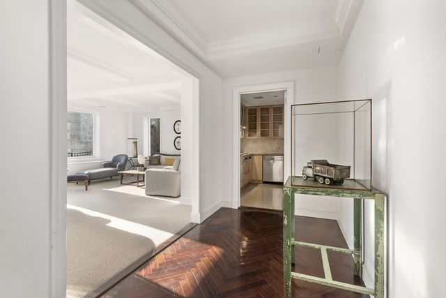 15 East 69th Street, Unit 10D Manhattan, NY 10021 - Photo 7 of 12 a living room with furniture and a table