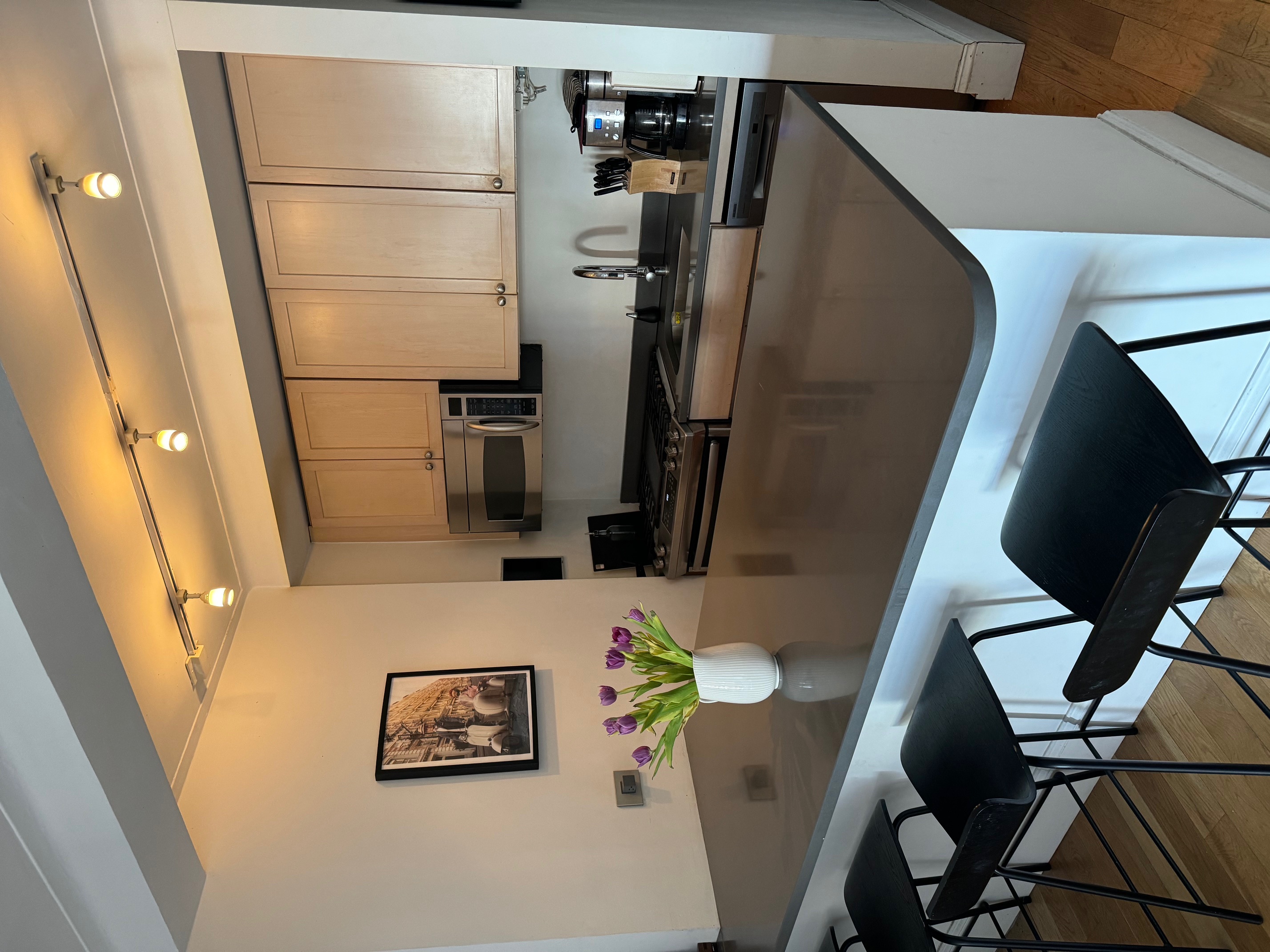 433 West 34th Street, Unit 6K Manhattan, NY 10001 - Photo 3 of 12 a kitchen with a table chairs stove and cabinets
