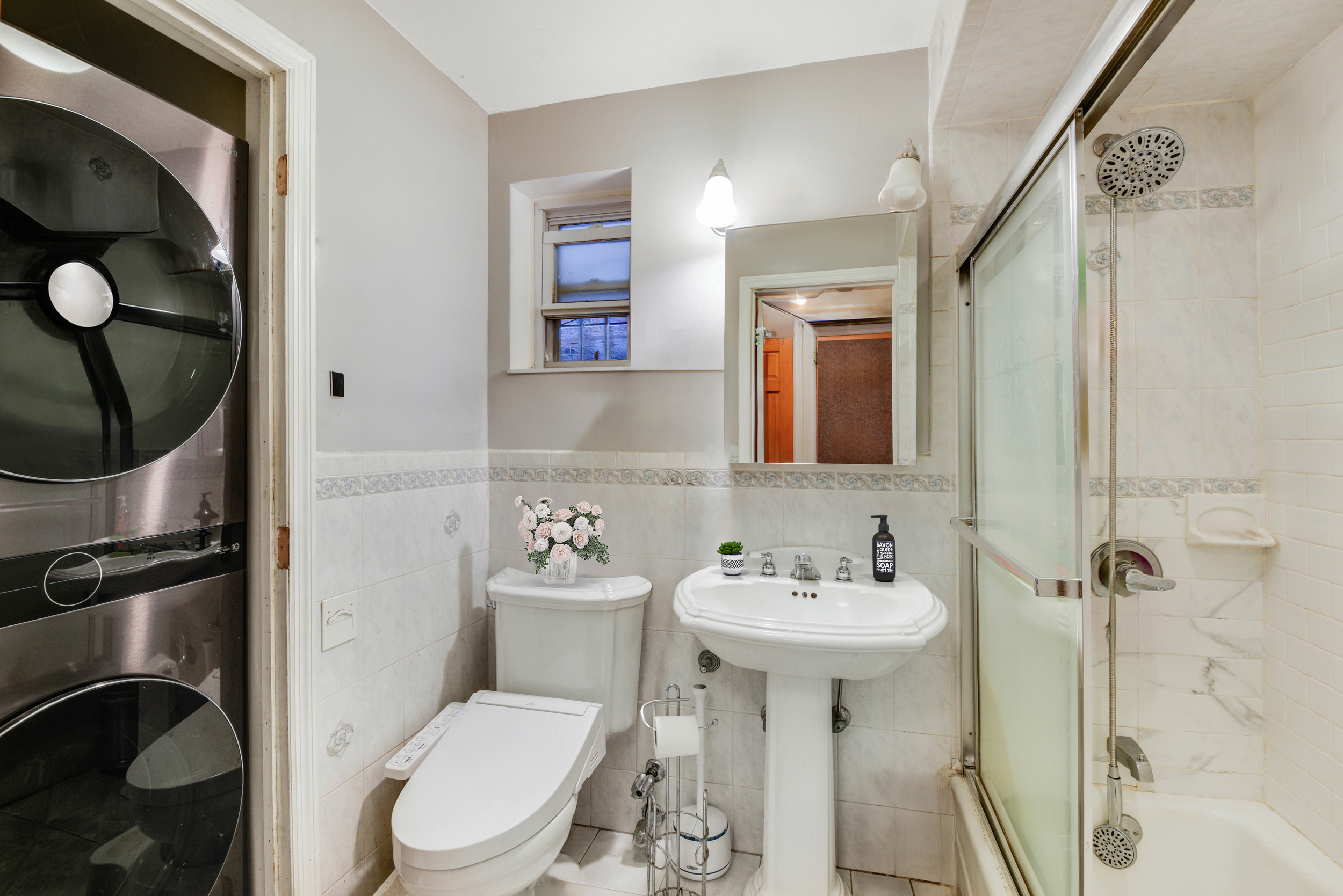 233 Battery Avenue Brooklyn, NY 11209 - Photo 7 of 17 a bathroom with a toilet sink and mirror
