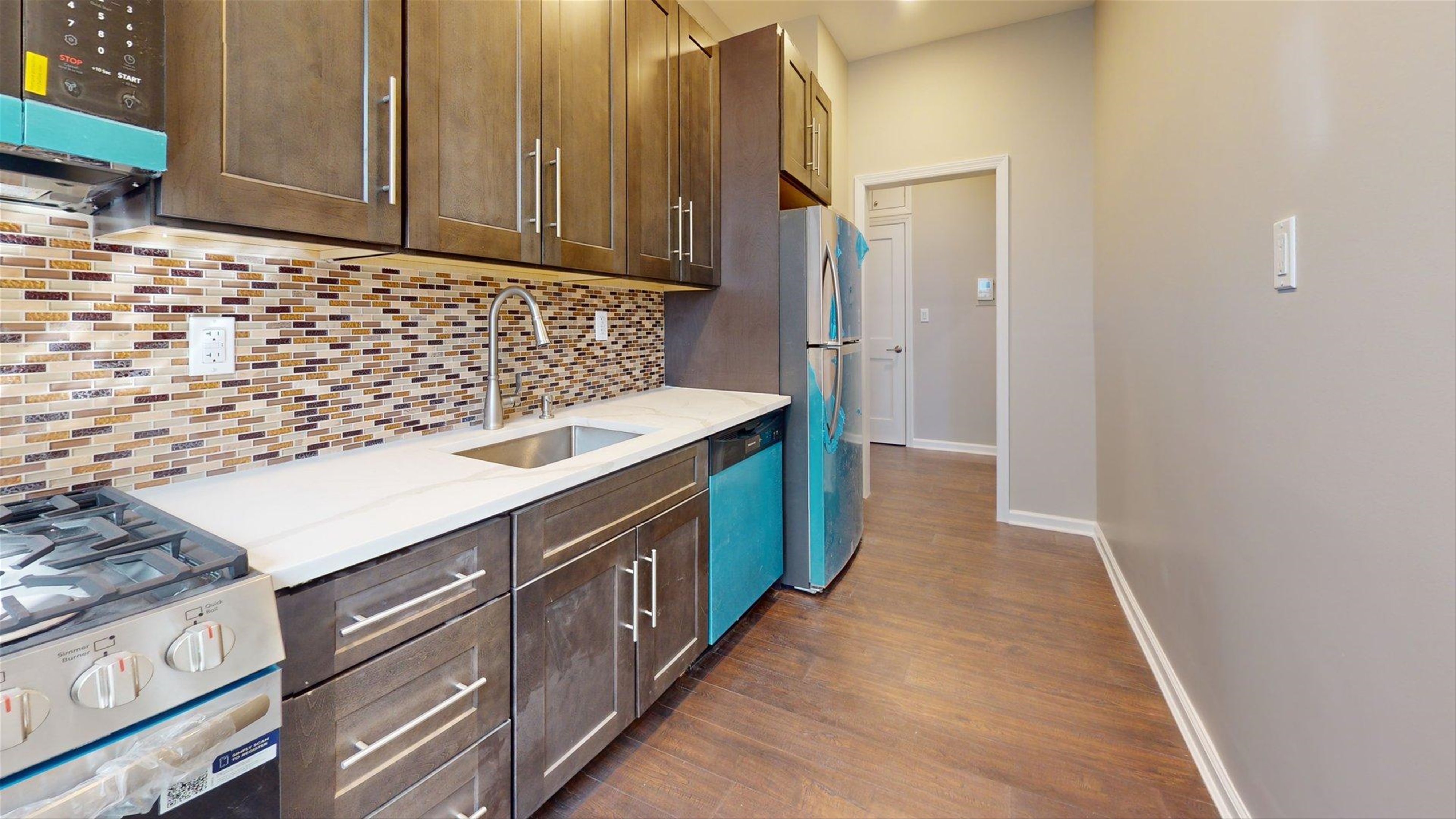 7609 4th Avenue, Unit E14 Brooklyn, NY 11209 - Photo 2 of 15 a kitchen with stainless steel appliances granite countertop a sink stove and cabinets