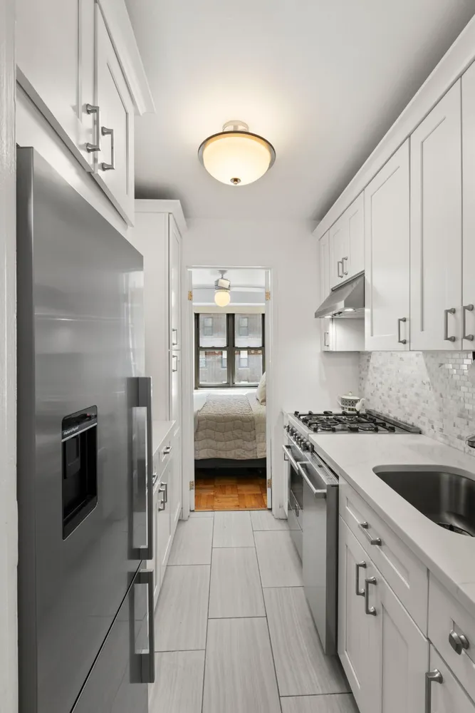 a kitchen with a sink cabinets and stainless steel appliances
