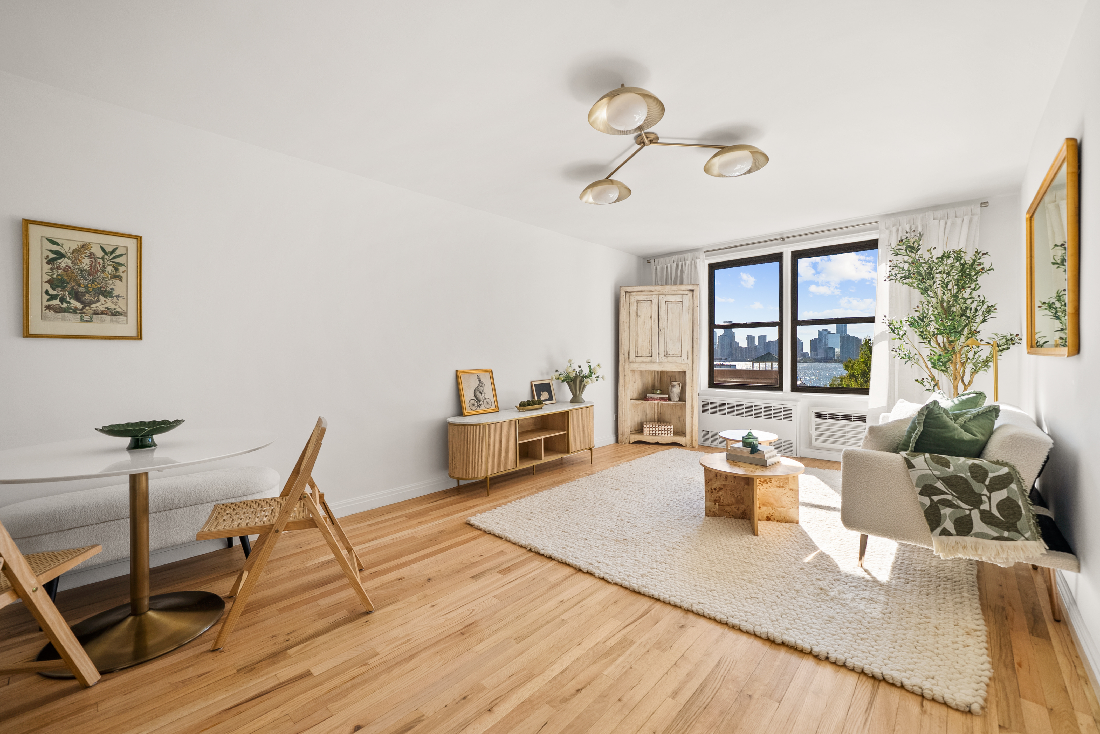 165 Christopher Street, Unit 6DD Manhattan, NY 10014 - Photo 3 of 8 a living room with furniture a wooden floor and next to a window