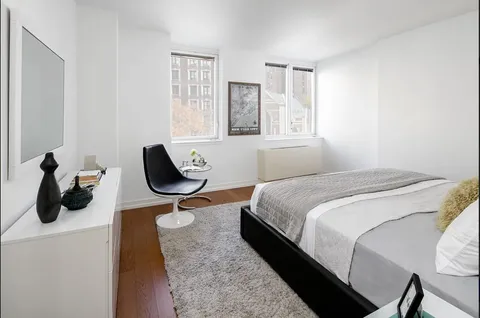 a bedroom with bed and window