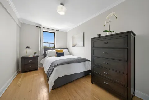 a bedroom with a bed and a dresser