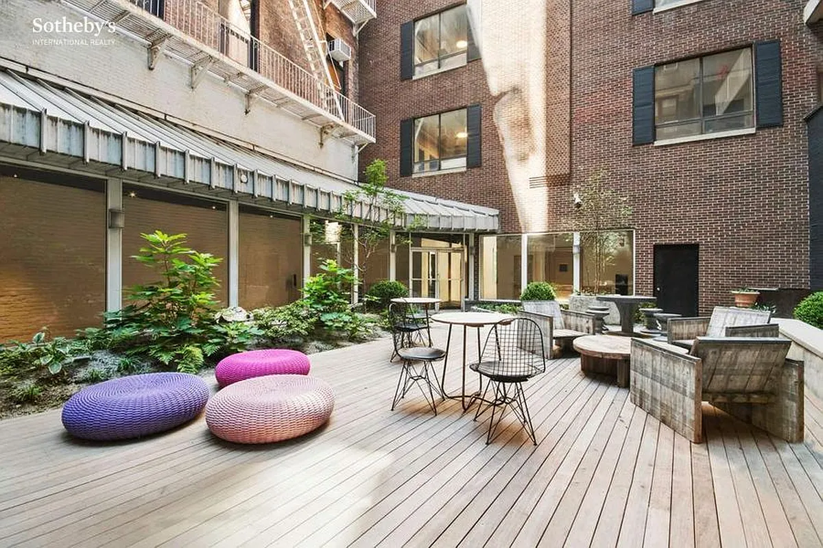 250 Mercer Street, Unit C308 Manhattan, NY 10012 - Photo 7 of 9 a view of a patio with couches and potted plants