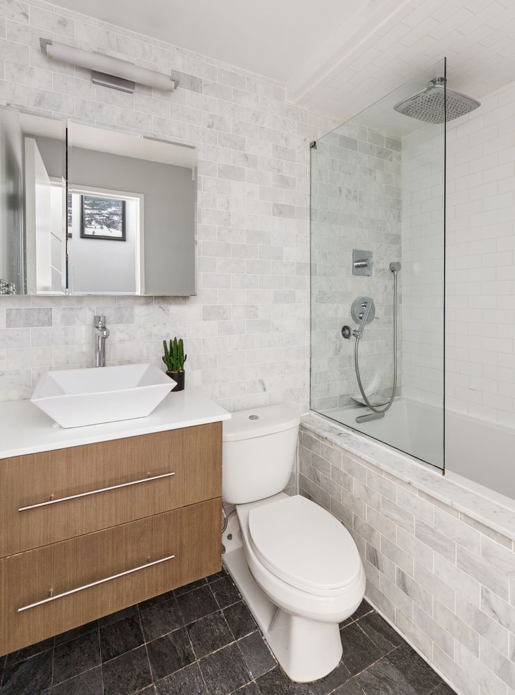 167 Perry Street, Unit 2F Manhattan, NY 10014 - Photo 5 of 11 a bathroom with a sink toilet and shower