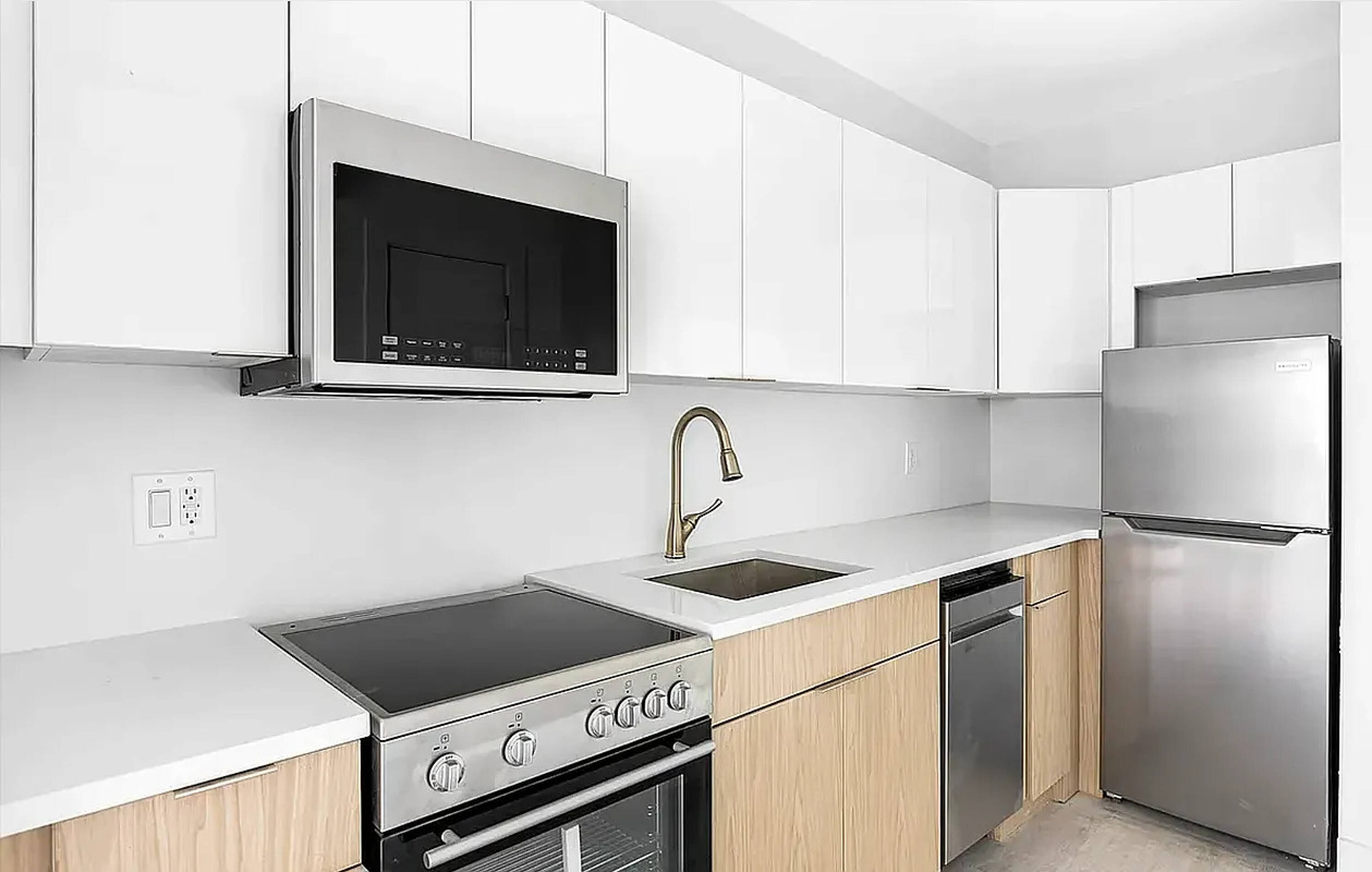 485 East 28th Street Brooklyn, NY 11226 - Photo 10 of 17 a kitchen with a stove and a microwave