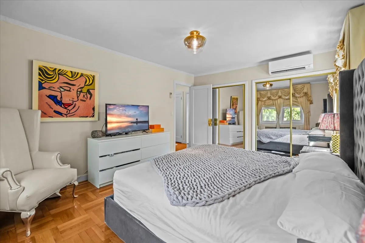 a bedroom with furniture and a flat screen tv