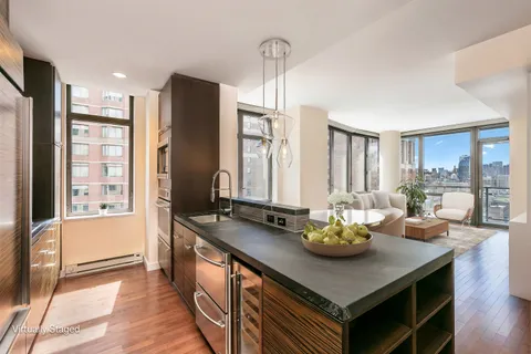 a kitchen with stainless steel appliances granite countertop a sink a stove and a refrigerator