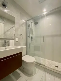 a bathroom with a sink toilet and shower