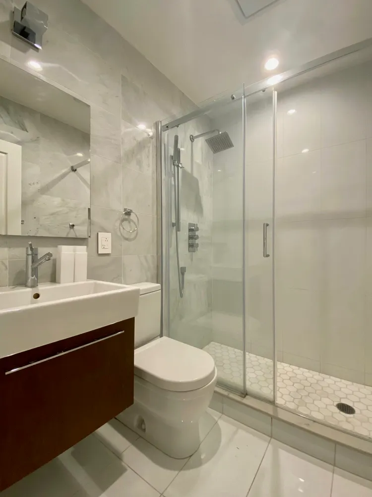 a bathroom with a sink toilet and shower