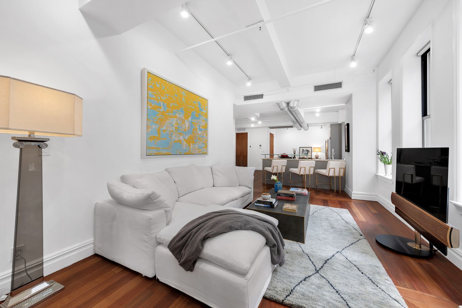 a living room with furniture and a flat screen tv