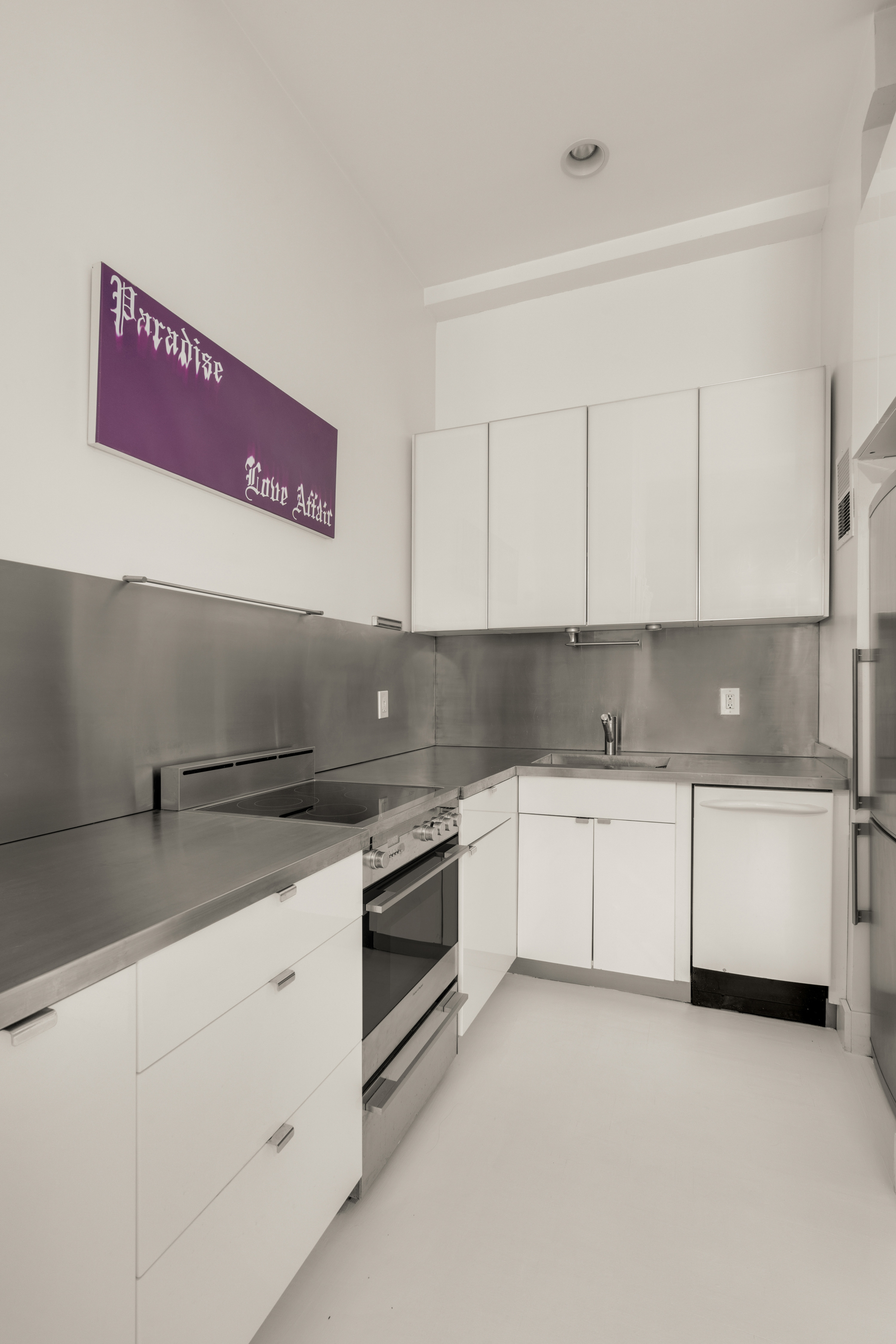 244 Madison Avenue, Unit PHE Manhattan, NY 10016 - Photo 9 of 20 a kitchen with granite countertop white cabinets and white stainless steel appliances