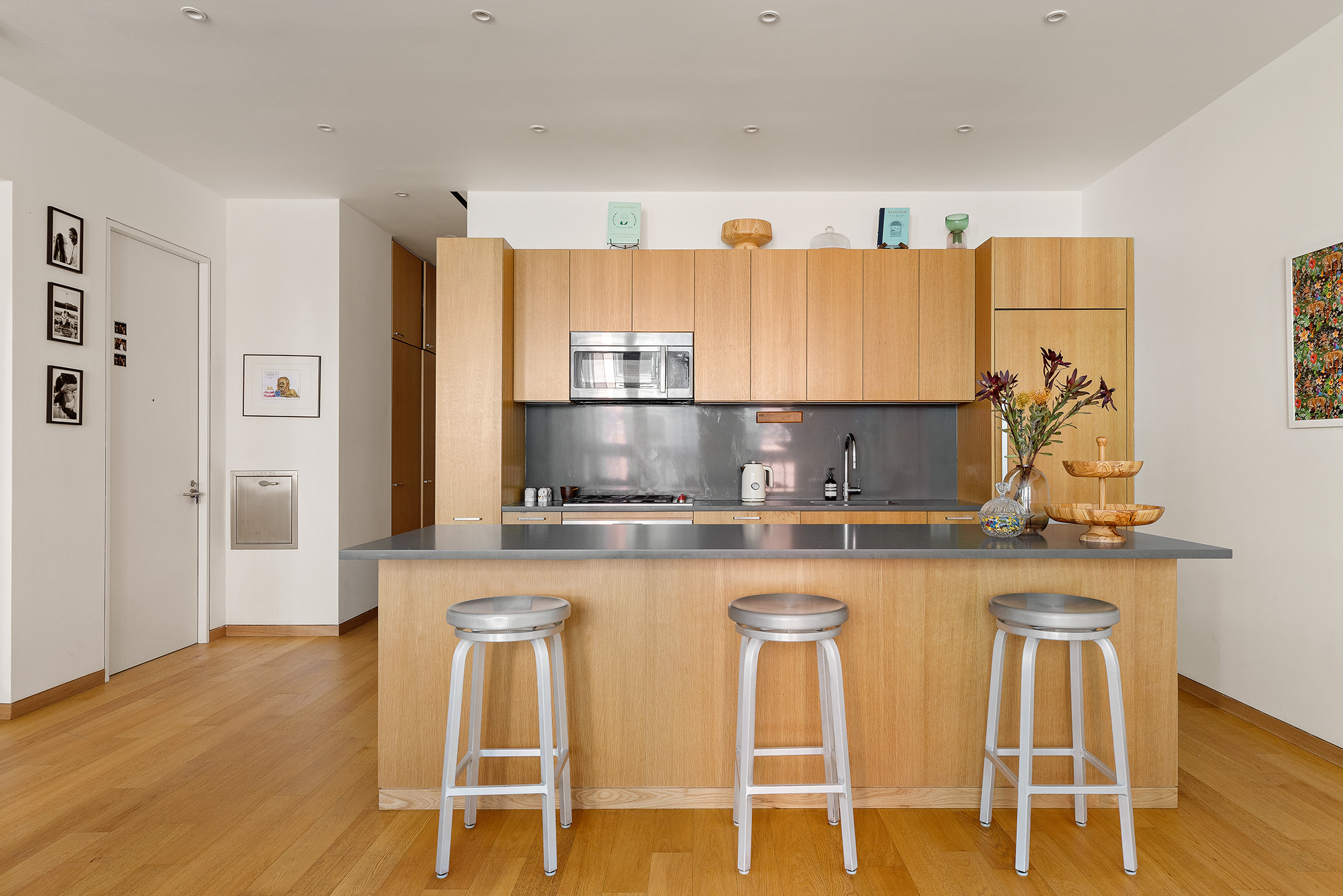68 Spring Street, Unit 3R Manhattan, NY 10012 - Photo 3 of 9 a kitchen with stainless steel appliances granite countertop a sink and cabinets