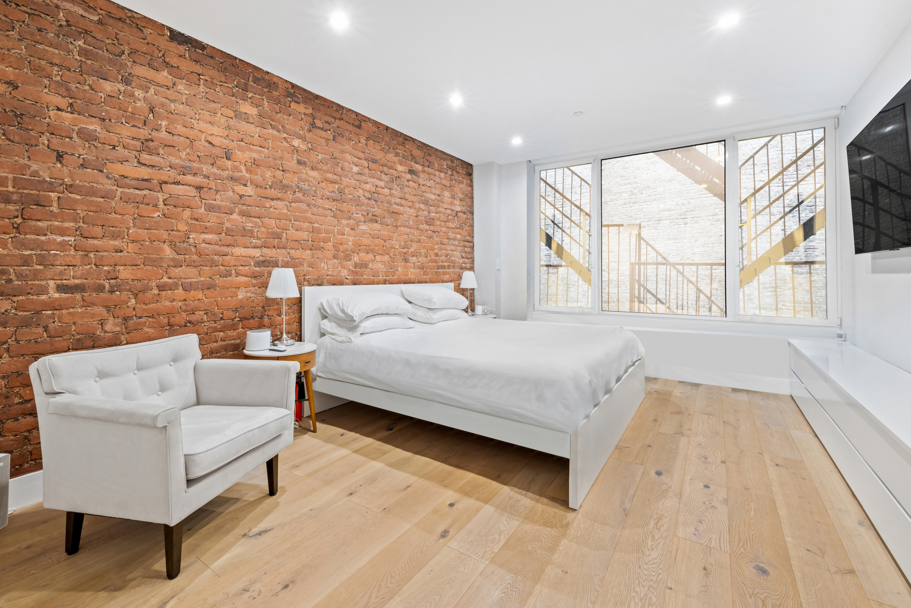 17 East 17th Street, Unit 4 Manhattan, NY 10003 - Photo 8 of 11 a bedroom with a bed and a large window