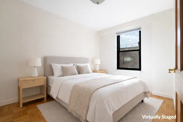 a bedroom with a bed and a night stand