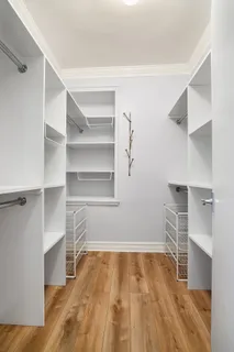 a view of walk in closet with empty racks