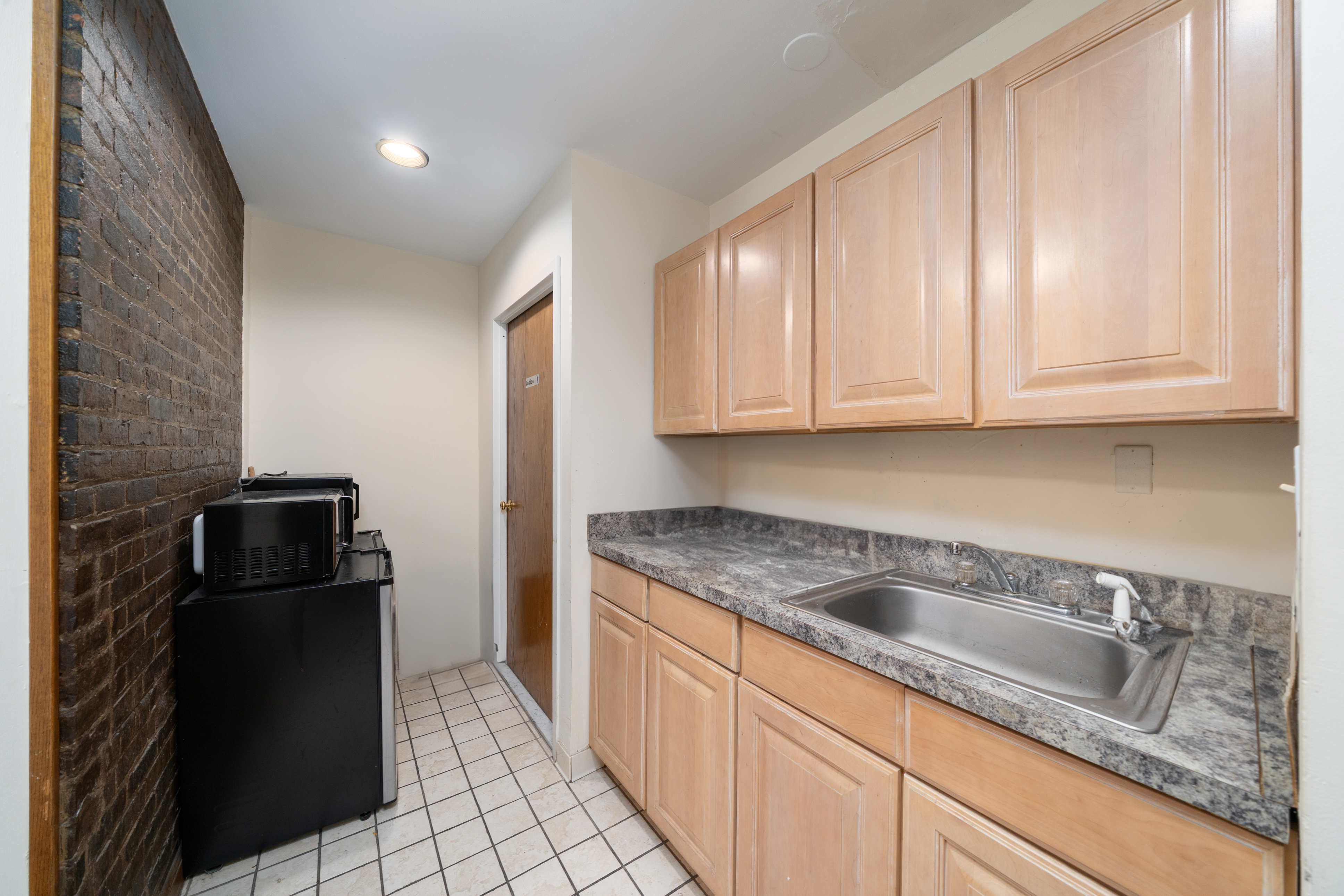 84 Washington Street Hoboken, NJ 07030 - Photo 10 of 11 a kitchen with granite countertop a refrigerator sink and cabinets