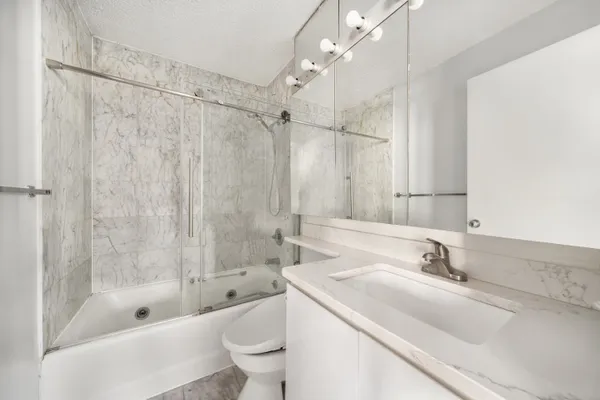 a bathroom with a sink a toilet and a bathtub