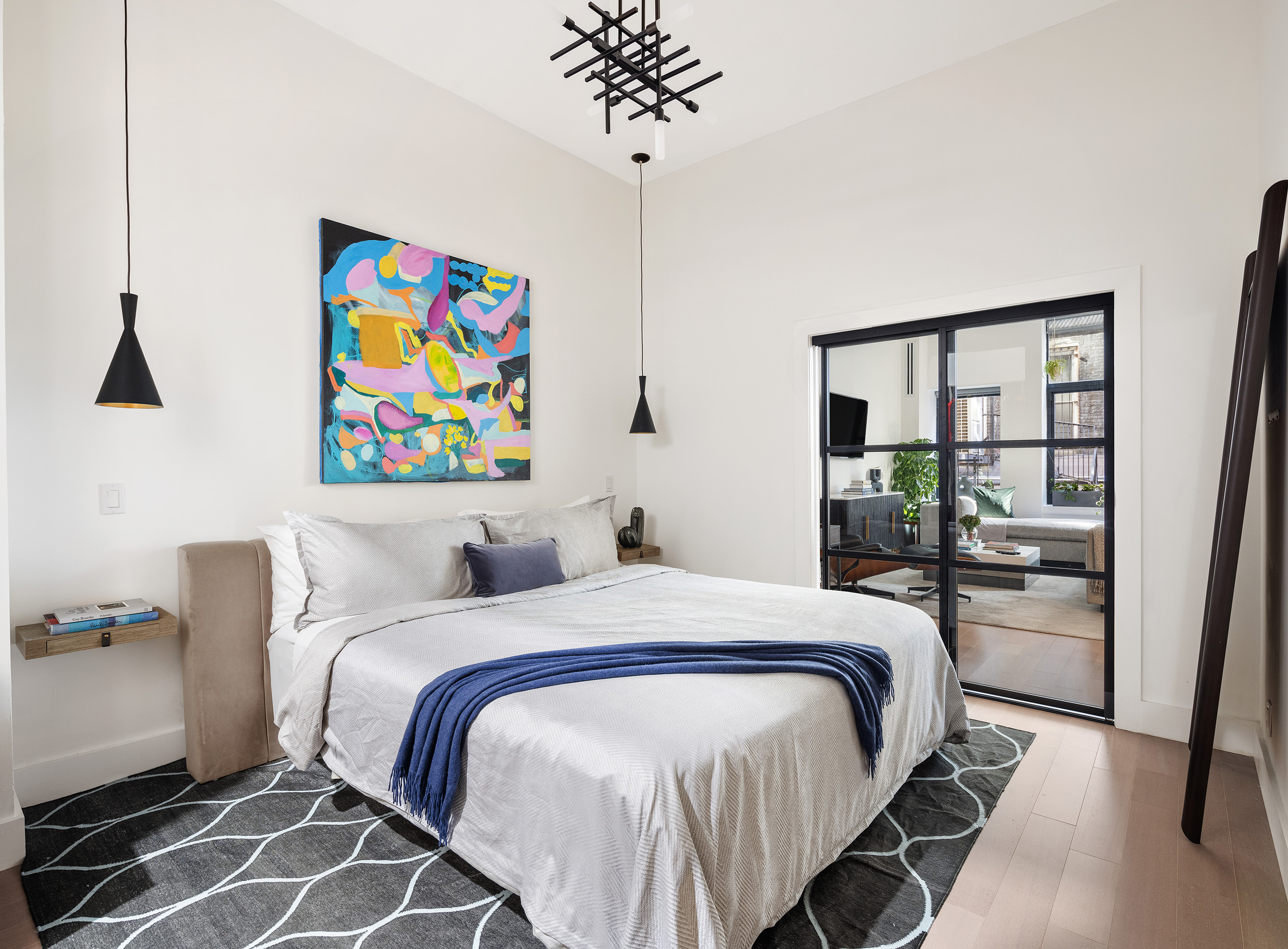 21 East 22nd Street, Unit 2A Manhattan, NY 10010 - Photo 5 of 10 a bedroom with a bed and a table in it