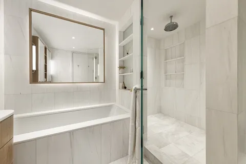 a bathroom with a bathtub and a shower